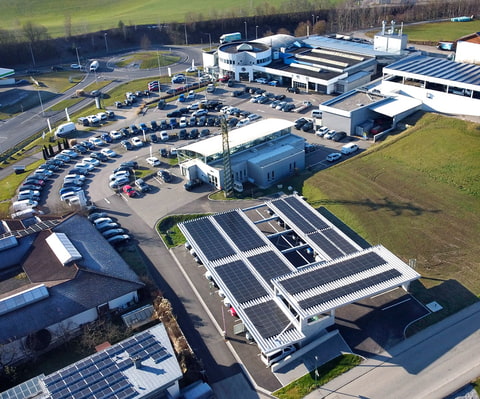 Drohnenaufnahme vom Solarcarport und Firmengebäude Drohnenaufnahme vom Solarcarport und Firmengebäude